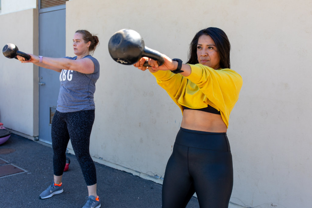 females working out with kettlebell
