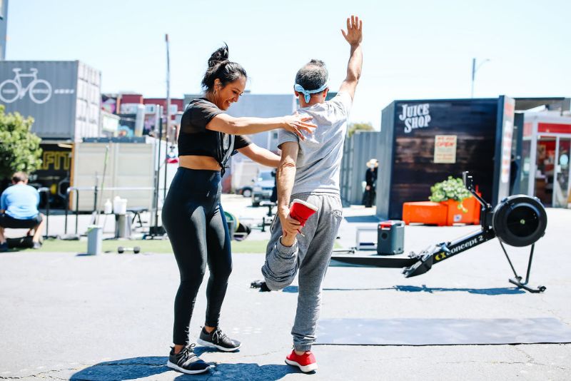 trainer helping client stretch